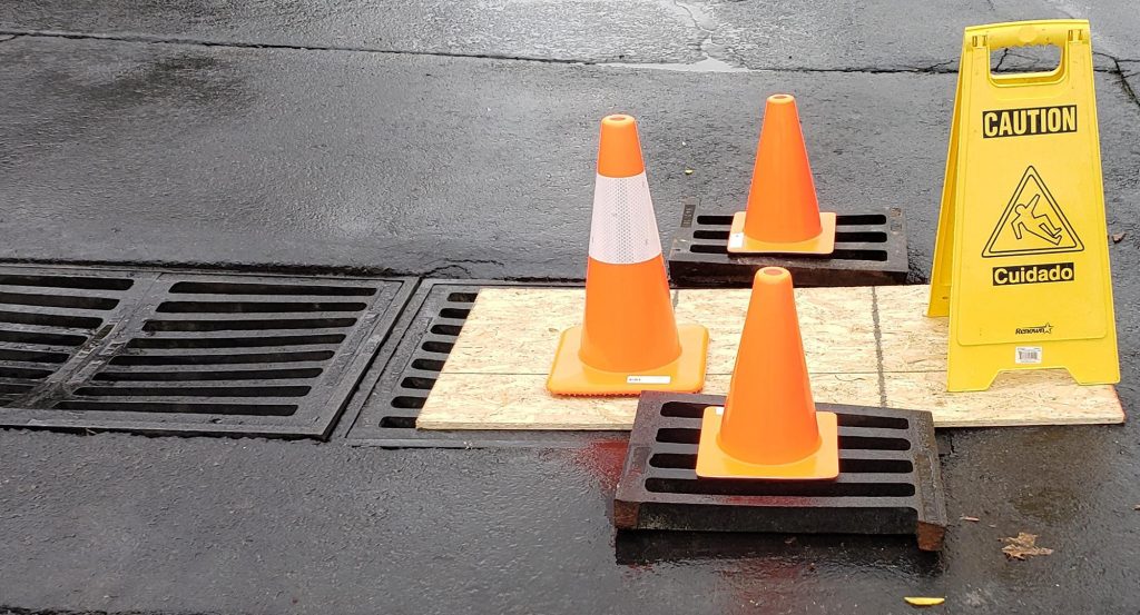 close up of drain and damage in parking lot