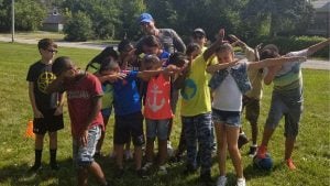 Let's Pave owner volunteering with children