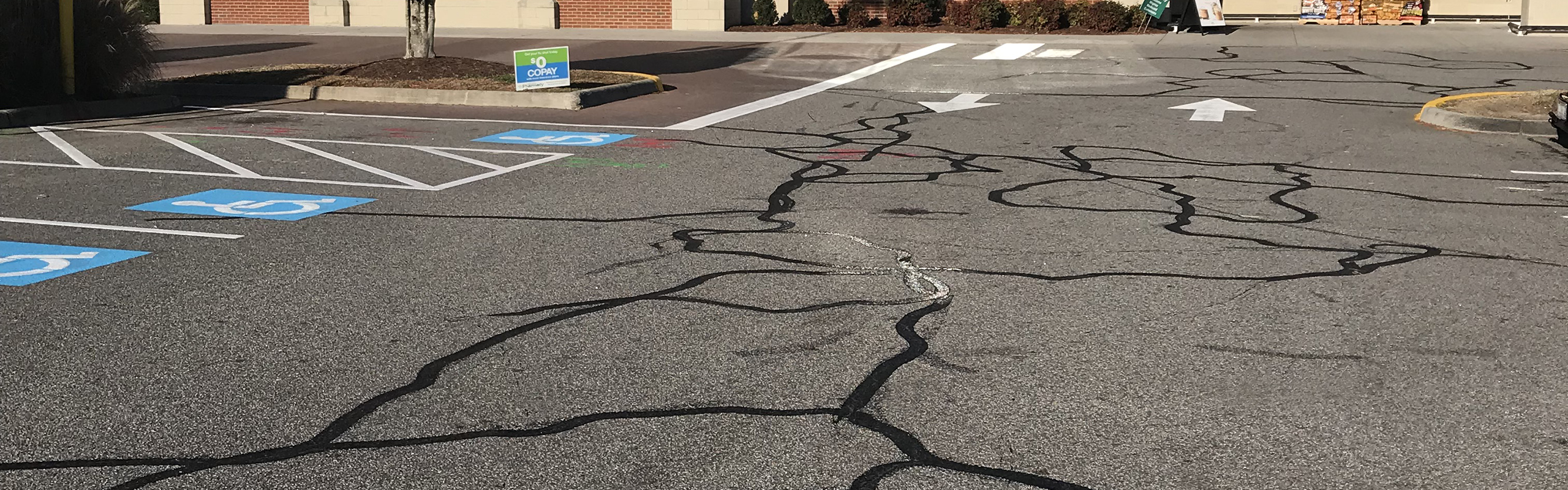 Asphalt crack sealing on block cracks in retail parking lot