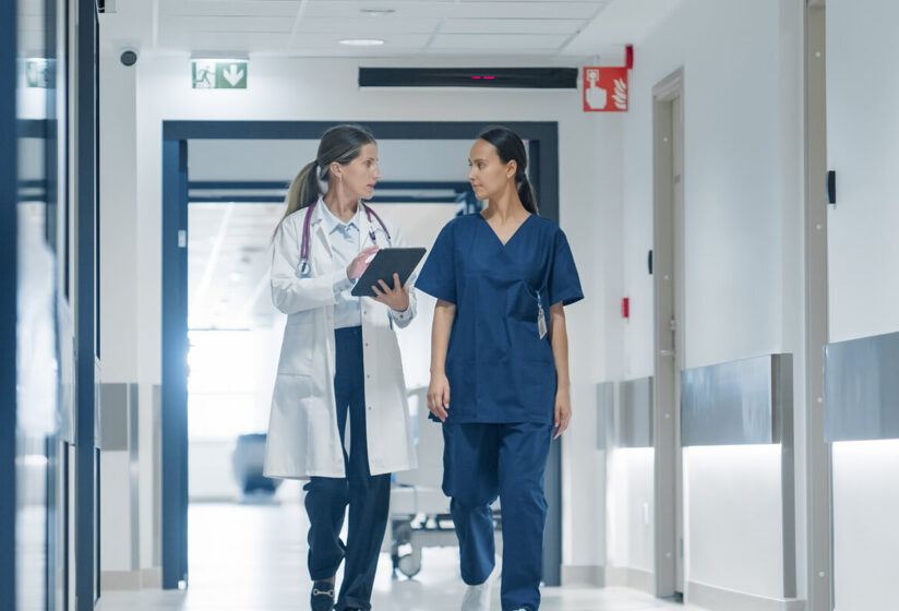 nurse and doctor walking down hallway