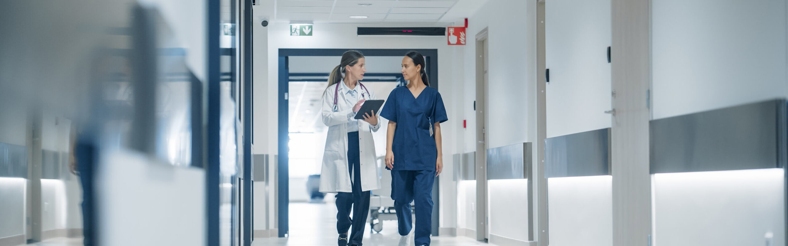 nurse and doctor walking down hallway